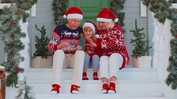 Grandparents Family with Granddaughter Taking Selfie on Mobile Phone Video Call Online Christmas alt