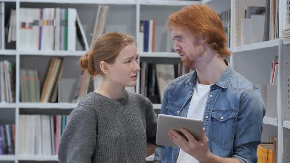 Young Teammates Reacting to Loss Email on Tablet PC, Upset alt