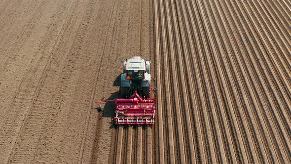 Tractor with Disc Harrows on the Farmland alt