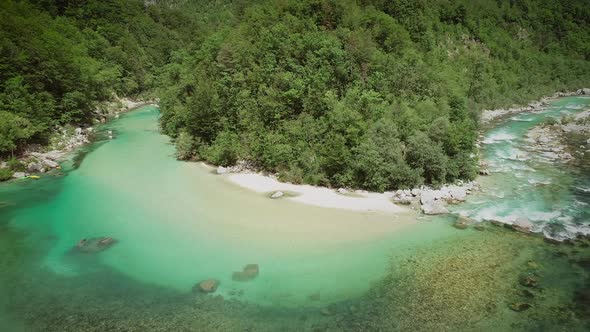 Aerial view of the calm and transparent water at the Soca river in Slovenia. alt