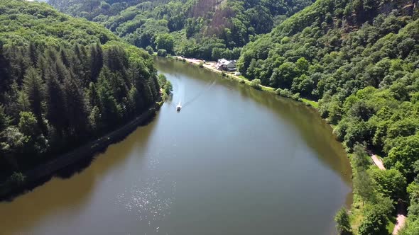 Aerial flight showing saar river curve with riding luxury boat during beautiful day alt