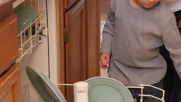 Mother and Son loading dishwasher together