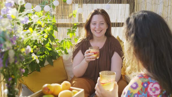 Women Drink Fresh Lemonade on Sunny Terrace