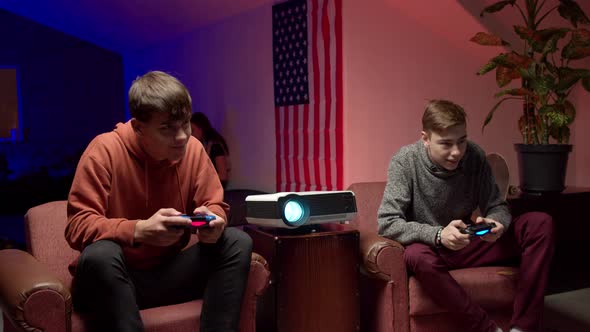 Cheerful Gamers with Joysticks Playing Video Game