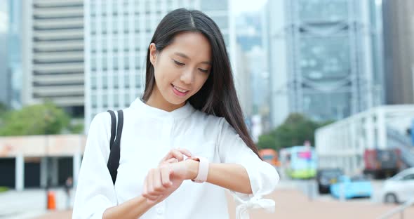 Businesswoman look at the smart watch alt