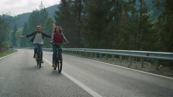 Lovers Cycling Mountain Bikes on Nature Road alt