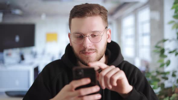 Man in Office with Smartphone