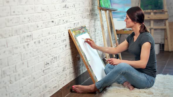 Talented Female Painter Making Graphic Picture on Canvas Using Pencil Full Shot alt