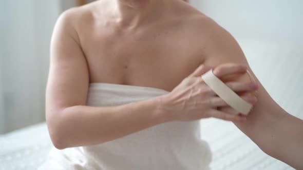 Close-up of female body with cellulite, woman makes self massage against cellulite with her hands alt