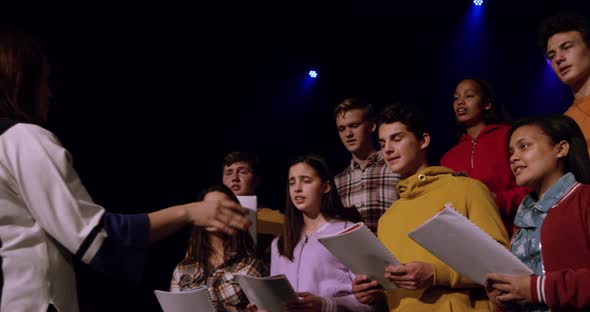 Teenagers rehearsing in a theatre alt