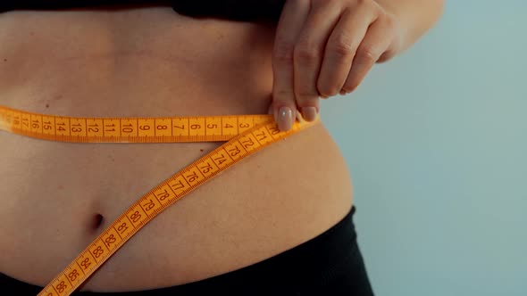 Girl Measuring Waist BMI Figure Measure Tape. Checking Body Weight Before Buy Underwear Clothes. alt