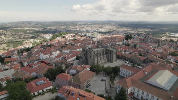 Aerial half orbit Guarda Downtown with Majestic ancient Cathedral, Portuguese Cityscape