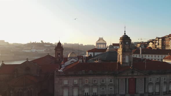 Reveal of Douro River embankment from Palácio da Bolsa in Porto, Portugal - Aerial slow pan shot alt