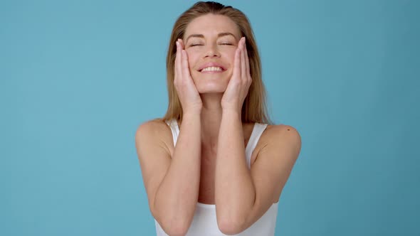 Woman Softly Putting on Skin Care on Her Face