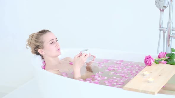 Beautiful Sexy Caucasian Blonde Girl In Bikini Lying In Flower Bath In Resort Day Spa Salon alt