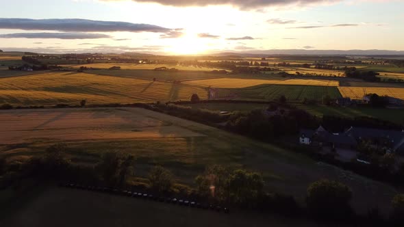 A Beautiful Sunset with Beautiful Green Fields in the Foreground alt