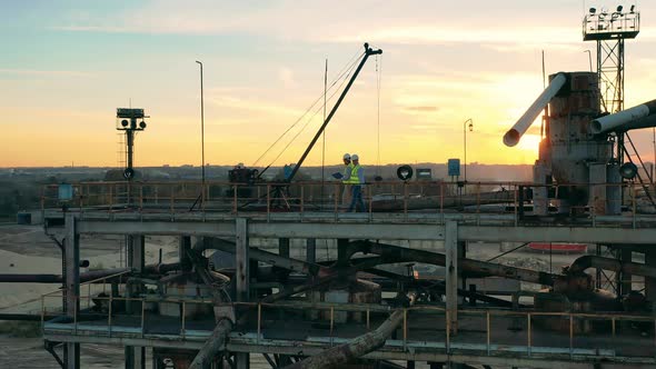 Engineers Are Walking Along a Massive Loading Platform in the Port alt