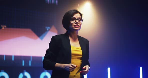 Business Coach Talking Against Graphs alt