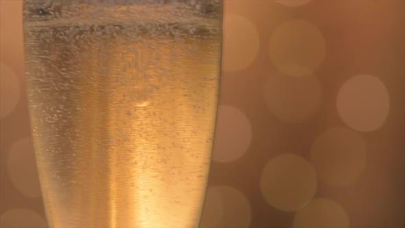 Champagne glasses over holiday bokeh blinking background
