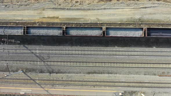 Freight Train Carries with Coal an Electric Locomotive - Aerial Footge, Top View alt