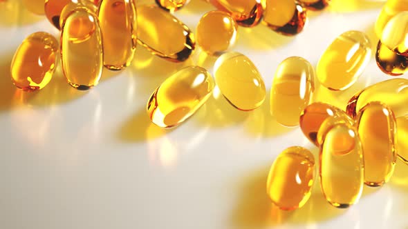 Seamless looping animation of yellow gel capsules with omega 3 or fish oil.