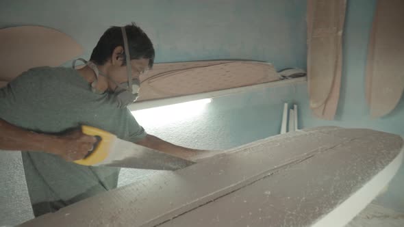 Artisan Using Saw to Shape Surfboard alt
