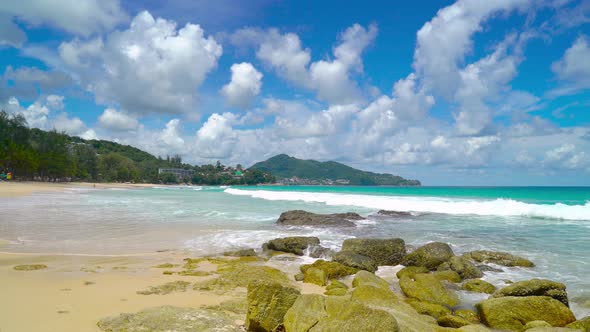 Seascape in sunny day white clouds beautiful blue sky rock and sand beach Phuket Thailand alt
