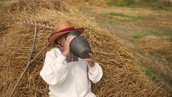 Thirsty Old Man Grandpa Drinks Water From Jug alt