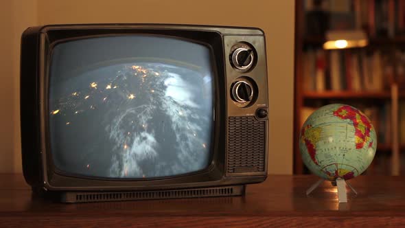 Our Planet from Space on a Retro TV and a Terrestrial Globe. alt