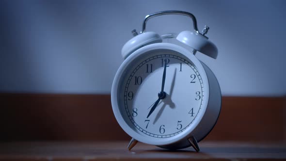 Closeup of a Classic Alarm Clock Ringing Early in the Morning Bedside Table alt