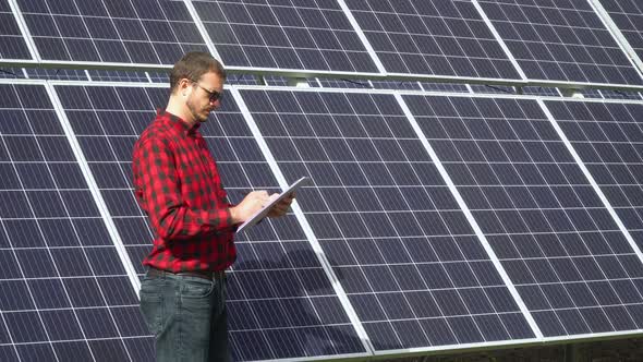 Successful Young Engineer Planning Futuristic Solar Panels Power Plant alt