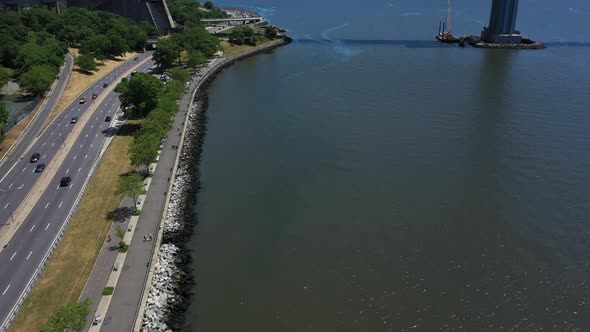 An aerial shot of the shores of Lower New York Bay near Shore Parkway in Brooklyn. It is a sunny day alt