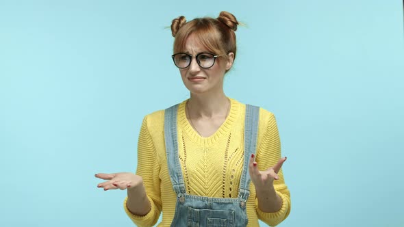 Confused Woman in Hipster Glasses with Bangs and Buns Hairstyle Frowning and Making Clueless Face