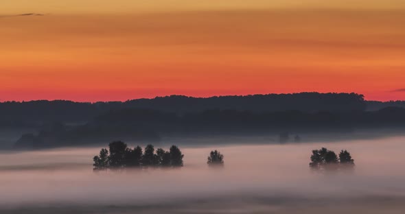 Early Morning View of Mist and Fog Moving Through the Meadow Landscape alt