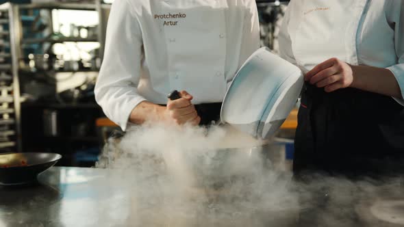 Professional kitchen: liquid nitrogen is added during the cooking of a molecular dish alt