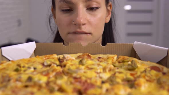 Sad Dieting Woman Looking at Pizza