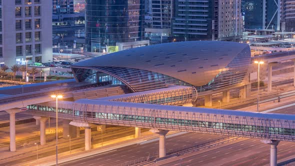 Aerial View of Jumeirah Lakes Towers Skyscrapers Night to Day Timelapse with Traffic on Sheikh Zayed alt
