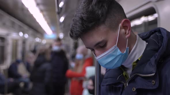 Brunette Young Male in Medical Mask in Metro Car alt