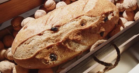 Open A Wooden Box With Walnuts And A Loaf Of Bread With Raisins And Nuts Inside