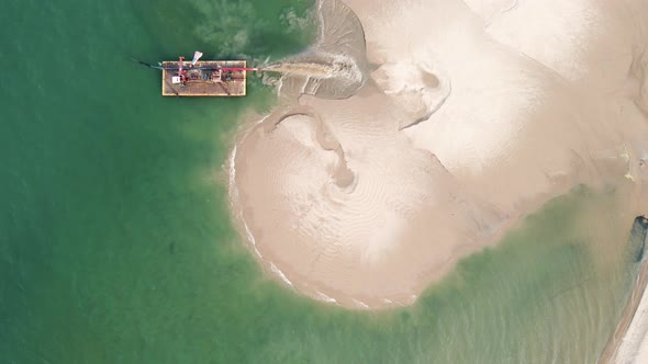 Rising over Lake Michigan as a barge pumps sand forward. alt