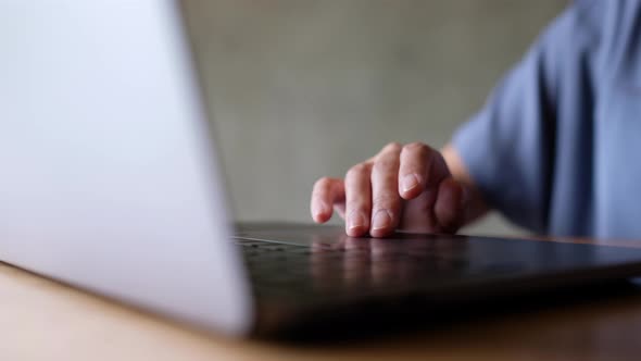 Closeup a woman working and touching on laptop computer touchpad on the table