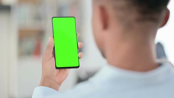 African Man Using Smartphone with Green Chroma Key Screen alt