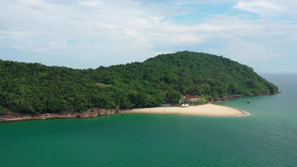 Aerial: island of pigs ubatuba brazil with view of the jungle and beach from the air and view of the alt