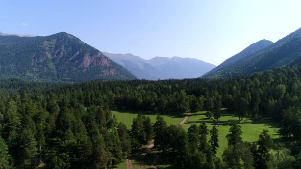 Caucasian Green Valley and Forest Against the Backdrop of Mountains alt