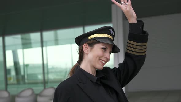 Portrait of Professional Female Pilot at Airport Terminal alt