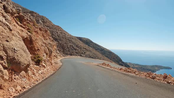 Zig-zag curve road and U-turns in a desert canyon. Coast POV driving in the mountains alt