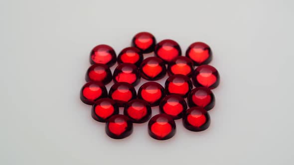 Natural Red Garnet Gemstone on the White Background on the Turning Table alt