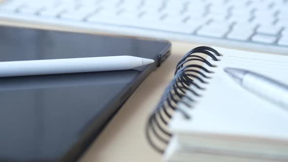 Close Up of Digital Tablet and Graphic on Table alt