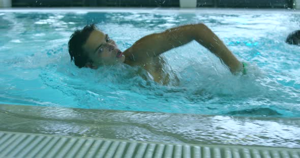 Young Man Crawl Swimming in the Pool