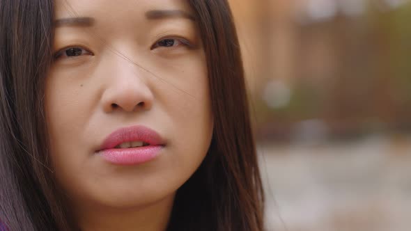 Chinese Woman Portrait: Thoughtful Young Asian Woman Looking at Camera alt